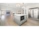 Spacious kitchen flowing into a large Gathering room, features a large center island with seating and stainless appliances at 6335 Mount Eden Ave, Las Vegas, NV 89139