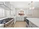 Bright, spacious kitchen features modern appliances, countertops, herringbone backsplash, and hardwood floors at 6335 Mount Eden Ave, Las Vegas, NV 89139