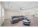 Spacious living room with a tray ceiling, fan, and comfortable sectional sofa at 6335 Mount Eden Ave, Las Vegas, NV 89139