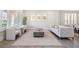 Bright and airy living room with modern furniture and hardwood floors, adjoining dining area at 6335 Mount Eden Ave, Las Vegas, NV 89139