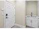 A well-organized mud room with ample storage, sink and white cabinetry at 6335 Mount Eden Ave, Las Vegas, NV 89139