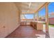 Covered outdoor kitchen features a built-in grill, countertop seating, and stucco walls at 6335 Mount Eden Ave, Las Vegas, NV 89139