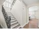 Elegant staircase featuring wrought iron railings and hardwood steps, leading to the upper level of the home at 6335 Mount Eden Ave, Las Vegas, NV 89139