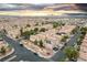 Expansive aerial view of a residential neighborhood showcasing uniform housing developments and landscaped streets at sunset at 6527 Belgrave Hall Ln, Las Vegas, NV 89122