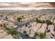 Extensive aerial view displays a community with uniform houses, green landscaping, and efficient street design at 6527 Belgrave Hall Ln, Las Vegas, NV 89122