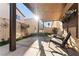 Inviting covered patio featuring outdoor seating, string lights, and a charming playhouse, perfect for relaxing and entertaining at 6527 Belgrave Hall Ln, Las Vegas, NV 89122