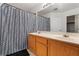 Bathroom featuring a dual sink vanity and a shower with a patterned curtain at 6527 Belgrave Hall Ln, Las Vegas, NV 89122