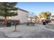 Community park with a picnic table, charcoal grill, mature trees and landscaping promoting outdoor recreation and relaxation at 6527 Belgrave Hall Ln, Las Vegas, NV 89122