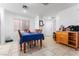 Bright dining area featuring neutral tile floors and a charming dining table at 6527 Belgrave Hall Ln, Las Vegas, NV 89122
