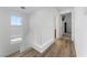 Bright hallway with hardwood floors, staircase and natural light at 6527 Belgrave Hall Ln, Las Vegas, NV 89122
