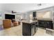 Open-concept kitchen with granite island overlooking a cozy living area at 6527 Belgrave Hall Ln, Las Vegas, NV 89122