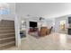 Open living area with tile floors, staircase, and access to the outdoor patio at 6527 Belgrave Hall Ln, Las Vegas, NV 89122