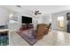 Cozy living room featuring tile floors, comfortable seating, and ample natural light at 6527 Belgrave Hall Ln, Las Vegas, NV 89122