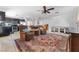 Inviting living room featuring tile floors, a ceiling fan, and dark cabinets in an open layout at 6527 Belgrave Hall Ln, Las Vegas, NV 89122