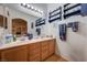 Bright bathroom with dual sinks, wood cabinetry, and decorative nautical themed shelving at 6705 Squaw Mountain Dr # 102, Las Vegas, NV 89130