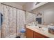 Bright bathroom featuring seashell-themed shower curtain, vanity, and blue accents at 6705 Squaw Mountain Dr # 102, Las Vegas, NV 89130