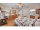 Inviting bedroom featuring wooden furniture, a ceiling fan, and an ensuite bathroom view at 6705 Squaw Mountain Dr # 102, Las Vegas, NV 89130