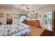Comfortable bedroom with a ceiling fan, ample storage, and natural light from a large window at 6705 Squaw Mountain Dr # 102, Las Vegas, NV 89130