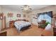 Comfortable bedroom featuring laminate floors, a ceiling fan, and ample natural light at 6705 Squaw Mountain Dr # 102, Las Vegas, NV 89130