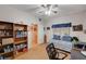 Bright bedroom featuring a ceiling fan, built-in bookshelves, and neutral walls at 6705 Squaw Mountain Dr # 102, Las Vegas, NV 89130