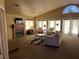 A clubhouse living room offers a cozy fireplace, comfortable seating and a TV for relaxation at 6705 Squaw Mountain Dr # 102, Las Vegas, NV 89130