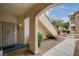 Inviting condo entrance with a secured gate, small green landscaping, and a welcoming walkway to the unit at 6705 Squaw Mountain Dr # 102, Las Vegas, NV 89130
