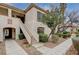 Charming condo featuring stucco exterior, desert landscaping, and convenient stair access to the upper level at 6705 Squaw Mountain Dr # 102, Las Vegas, NV 89130