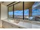 Kitchen sink under a picture window with stunning city views, perfect for enjoying while doing dishes at 677 Overlook Rim Dr, Henderson, NV 89012