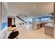 Open-concept living area with a modern staircase, tiled floors, and large windows offering scenic views at 677 Overlook Rim Dr, Henderson, NV 89012