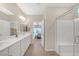 Open bathroom with dual sinks, a walk-in shower, and access to the bedroom, designed for modern living at 7177 W Camero Ave, Las Vegas, NV 89113