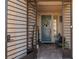 Front entryway featuring custom iron security gate, brick floor, and updated, modern door at 7177 W Camero Ave, Las Vegas, NV 89113