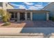 Inviting single-story home featuring a brick driveway, low maintenance yard, and modern architecture at 7177 W Camero Ave, Las Vegas, NV 89113