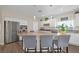 Bright kitchen featuring an island, stainless steel appliances, granite counters, and tile backsplash at 7177 W Camero Ave, Las Vegas, NV 89113