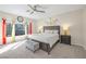 Bright bedroom featuring a ceiling fan, large windows, and cozy decor, offering a peaceful retreat at 7177 W Camero Ave, Las Vegas, NV 89113