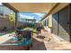 Inviting outdoor patio with comfortable seating and a fire pit, ideal for relaxation and entertaining at 7177 W Camero Ave, Las Vegas, NV 89113