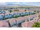 Aerial view of residential community showcasing rooftops, lush trees and views of the surrounding mountains at 7300 Pirates Cove Rd # 2093, Las Vegas, NV 89145
