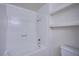 Bathroom with tiled shower-tub combo and built-in shelving for storage at 7300 Pirates Cove Rd # 2093, Las Vegas, NV 89145