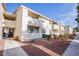Exterior view of the condo building featuring a low-maintenance landscape and a concrete walkway at 7300 Pirates Cove Rd # 2093, Las Vegas, NV 89145