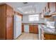 Traditional kitchen design with wood cabinets, a white refrigerator, and modern appliances at 7300 Pirates Cove Rd # 2093, Las Vegas, NV 89145