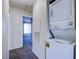 Convenient laundry area with stacked washer and dryer in the hallway at 7300 Pirates Cove Rd # 2093, Las Vegas, NV 89145