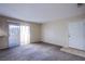 Cozy living room featuring plush carpeting and a sliding glass door that lets in natural light at 7300 Pirates Cove Rd # 2093, Las Vegas, NV 89145