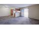 Bright and airy living room with plush carpeting, a sliding glass door, and a kitchen view at 7300 Pirates Cove Rd # 2093, Las Vegas, NV 89145