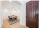 Dining room with a dark wooden door, modern chandelier, wainscoting, and seating for six at 7466 Matilda St, Las Vegas, NV 89113
