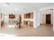 Open living area with a kitchen, large island, dining area, and built-in shelving at 7466 Matilda St, Las Vegas, NV 89113