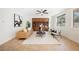 Cozy living room with neutral paint, a ceiling fan, built-in shelving, and large windows at 7466 Matilda St, Las Vegas, NV 89113