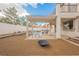 Inviting patio featuring a built-in grill, a fire pit, and a pergola for outdoor entertaining at 7466 Matilda St, Las Vegas, NV 89113