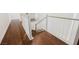 Staircase with wood flooring, white railing, and natural light at 7466 Matilda St, Las Vegas, NV 89113