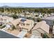 Aerial view of a neighborhood featuring a two-story home with solar panels and desert landscaping at 7652 Borealis St, Las Vegas, NV 89123