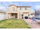 Large backyard featuring a well-maintained lawn, patio, trampoline, and exterior of the two-story home at 7652 Borealis St, Las Vegas, NV 89123
