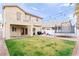 Spacious backyard showcasing a well-kept lawn, patio area, trampoline, and home exterior at 7652 Borealis St, Las Vegas, NV 89123